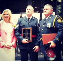 Peel Regional Police Det. Shane McFadden (centre) is awarded the 2016 Police Merit Award. He's flanked by Mississauga Mayor Bonnie Crombie and Deputy Chief Brian Adams at City Hall on Thursday, May 26, 2016. McFadden played a key role in a March 2015 drug seizure, taking 15 kilograms of cocaine off the street. Seven months later, his instinct at a crime scene led to an arrest in a murder case. (Photo: Kelly Roche/QEW South Post)